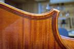 Detailed view of the corner and purfling on a Burgess cello.
